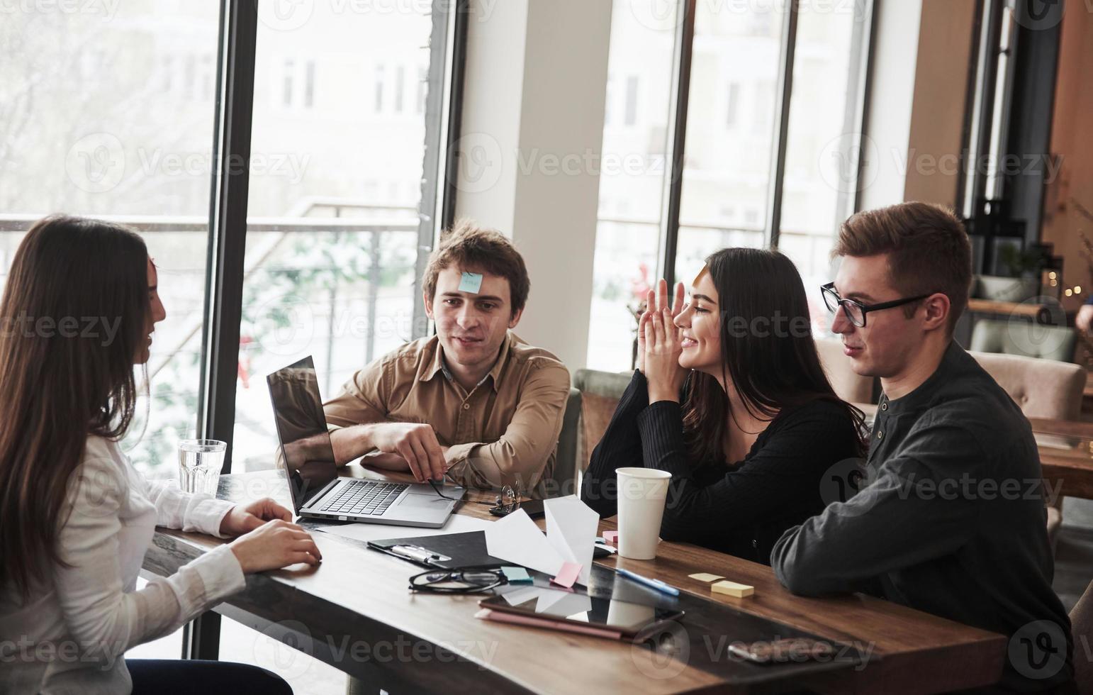 Thinking about some ideas. Having fun in the office room. Friendly coworkers playing around at their break time photo