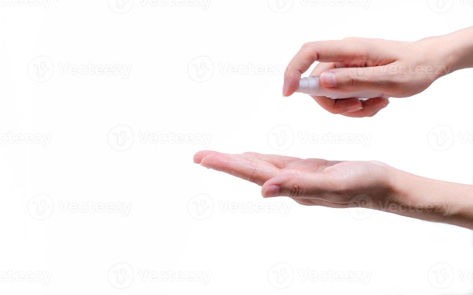 Woman hand hold alcohol bottle and spray on palm to protect and kill coronavirus and cleaning hand. Personal hygiene to prevent coronavirus or flu epidemic. Cleaning hands from germs, virus, bacteria. photo