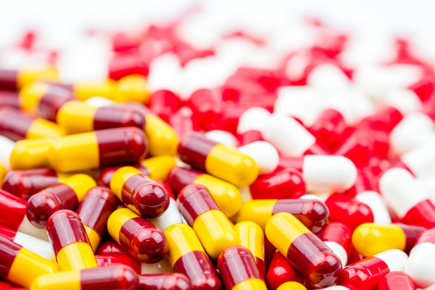 Selective focus of antibiotic capsules pills on blur capsule background. Drug resistance concept. Antibiotics drug use with reasonable and global healthcare concept. photo