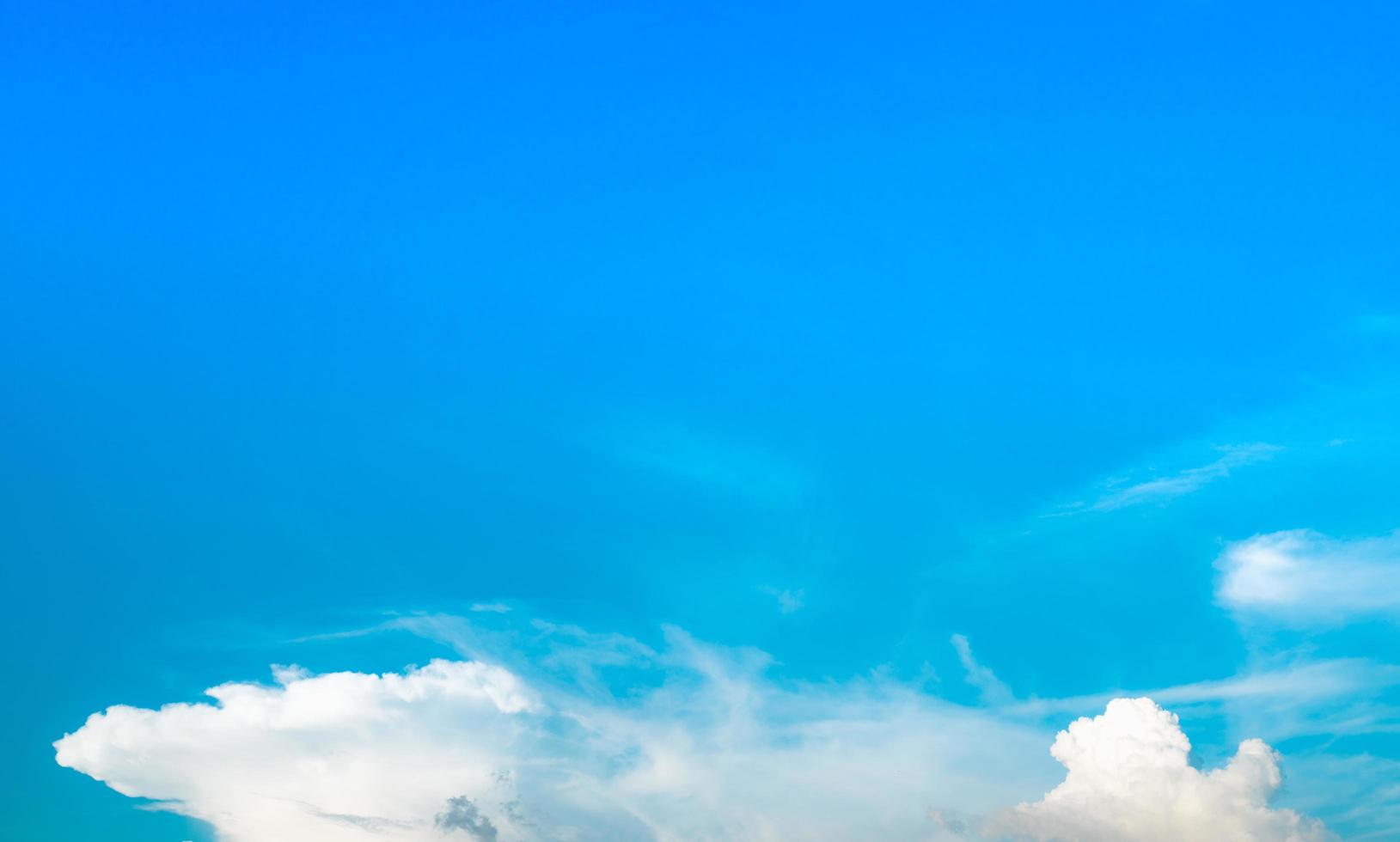 Beautiful blue sky and white cumulus clouds background. Background for peace, summer, bright day. Use for happy mood, fun and vacation day on summer background photo