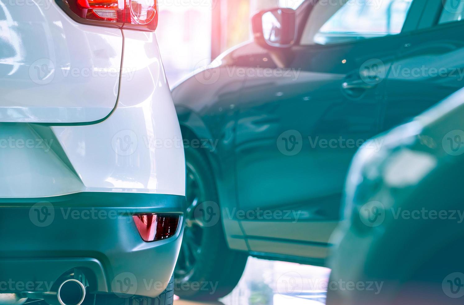 Selective focus white car parked in luxury showroom. Car dealership office. New car parked in modern showroom. Car for sale and rent business concept. Automobile leasing and insurance background. photo