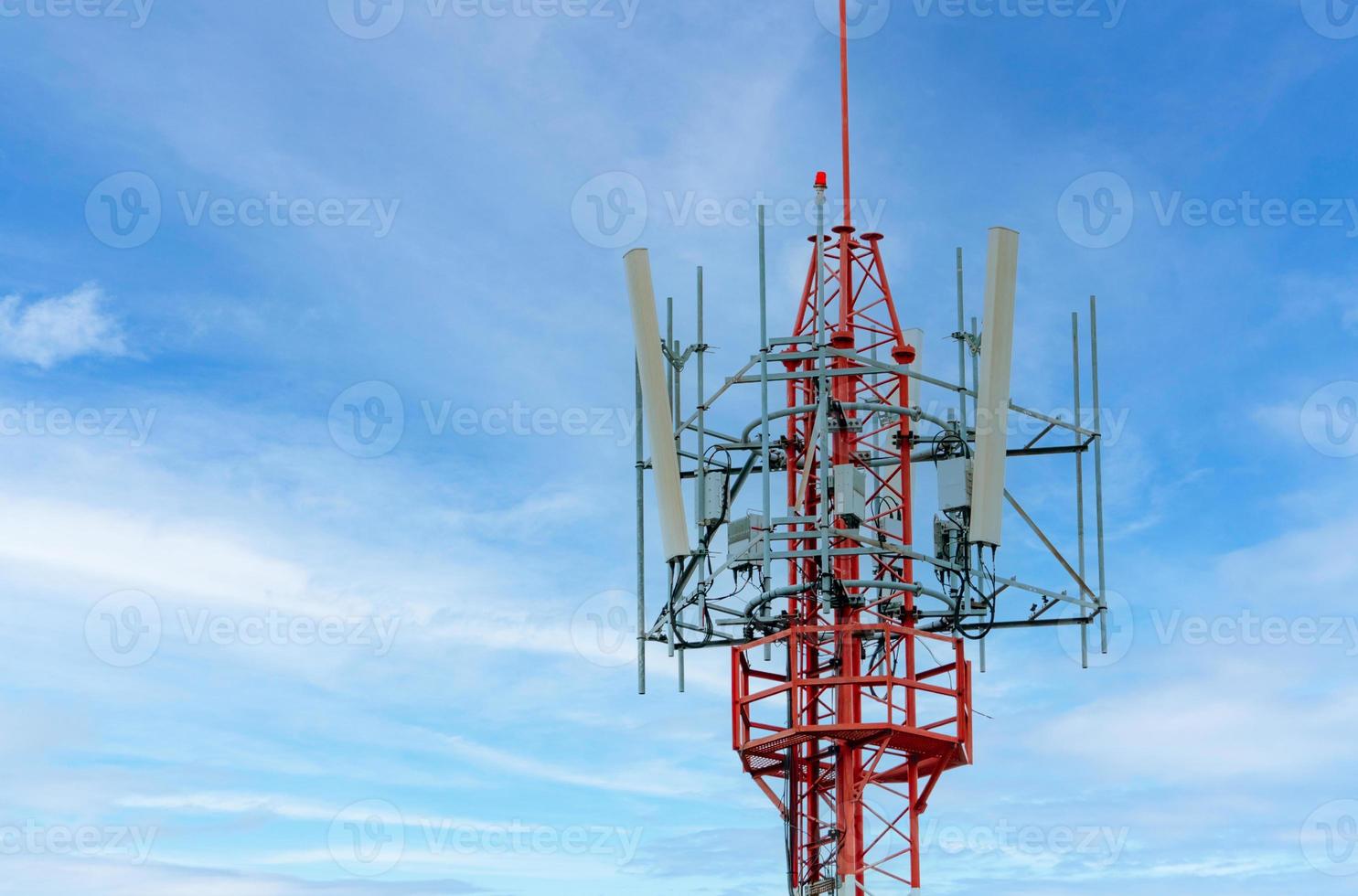 Telecommunication tower with blue sky and white clouds background. Antenna on blue sky. Radio and satellite pole. Communication technology. Telecommunication industry. Mobile or telecom 4g network. photo