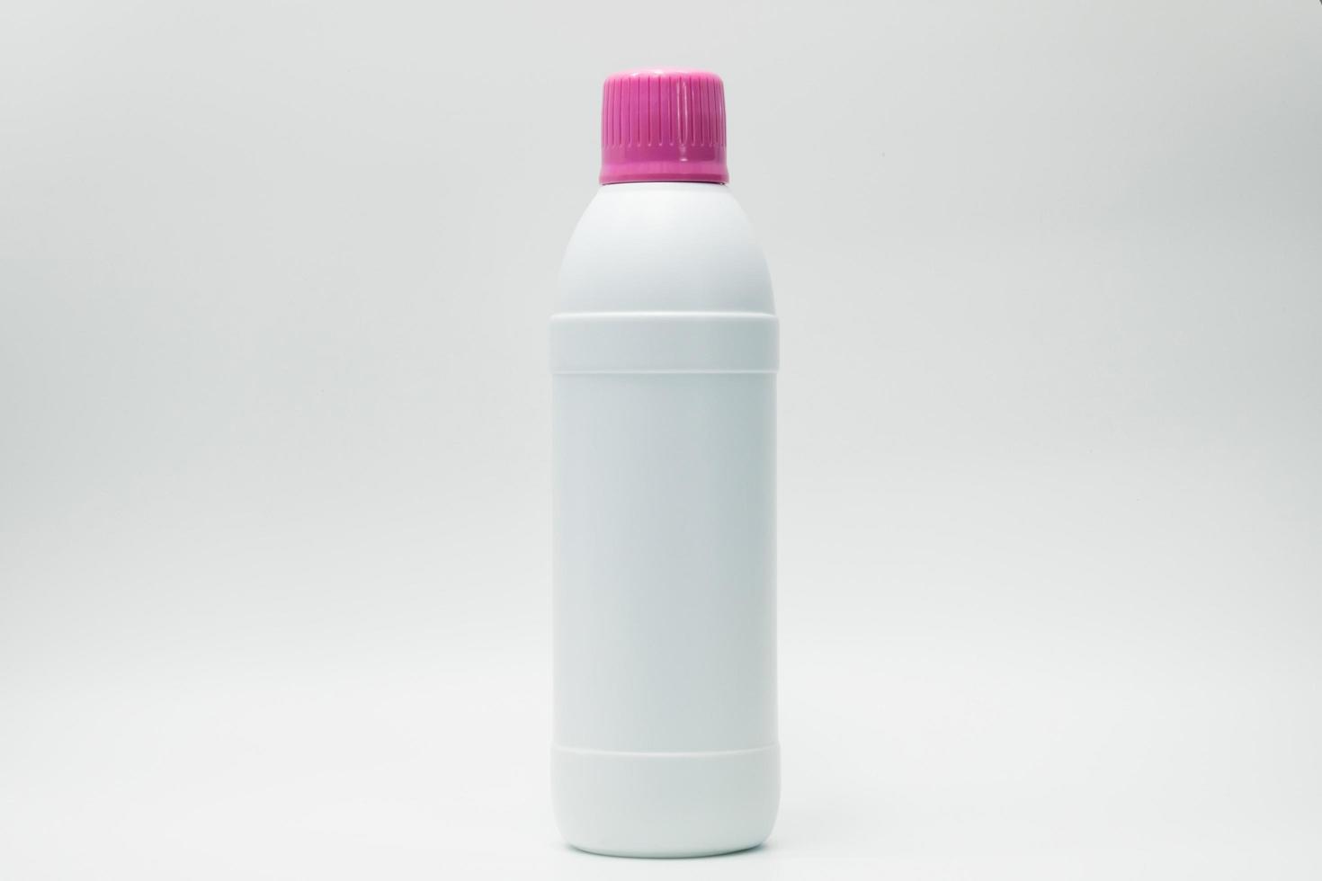 White plastic bottle with pink cap isolated on white background with copy space and blank label. Cleaning products container. Bathroom cleaner bottle.  Household Chemical bottle for cleaning toilet. photo