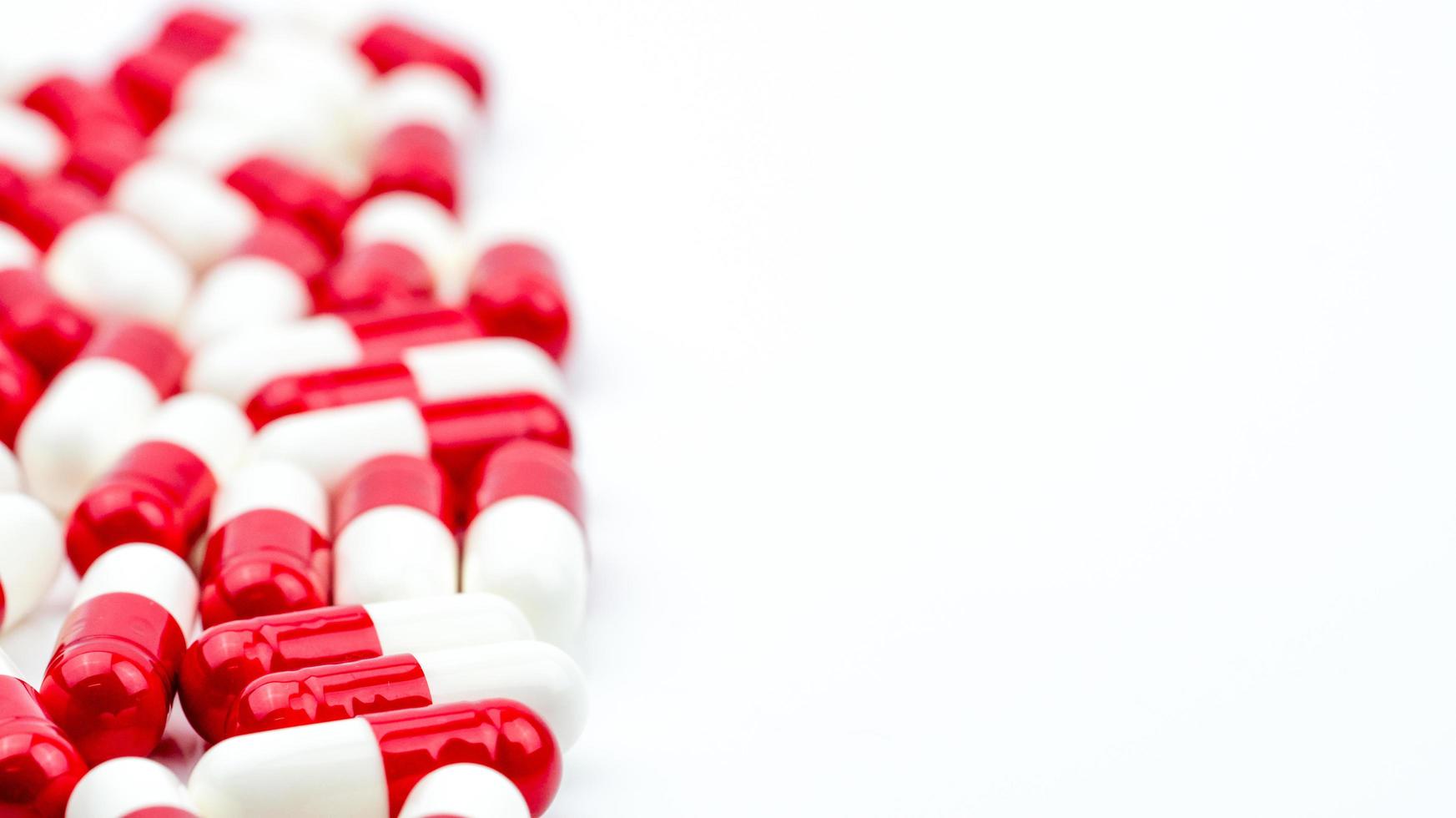 Selective focus of antibiotic capsules pills on white background with copy space. Drug resistance concept. Antibiotics drug use with reasonable and global healthcare concept. photo