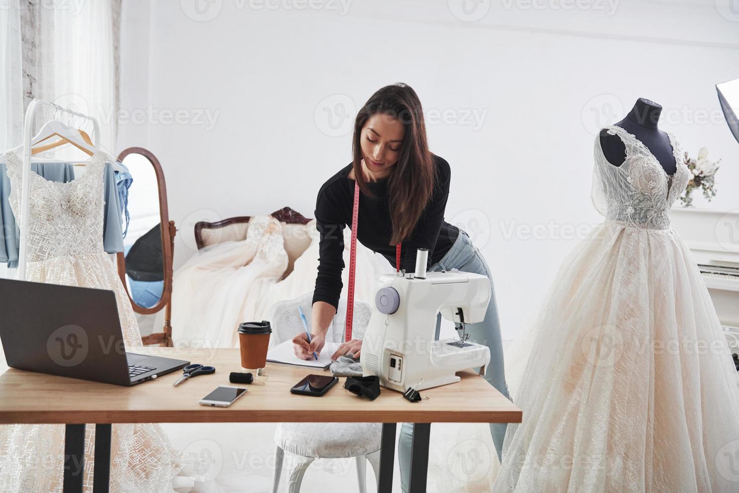 Modern room. Female fashion designer works on the new clothes in the workshop photo