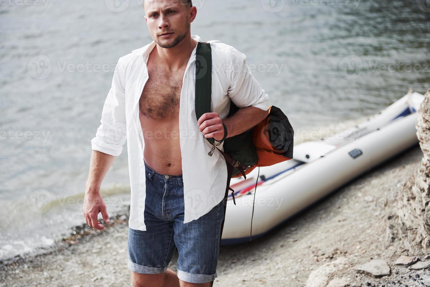 A young man is traveling with a backpack using a boat. The way of life of travel and nature with nature photo