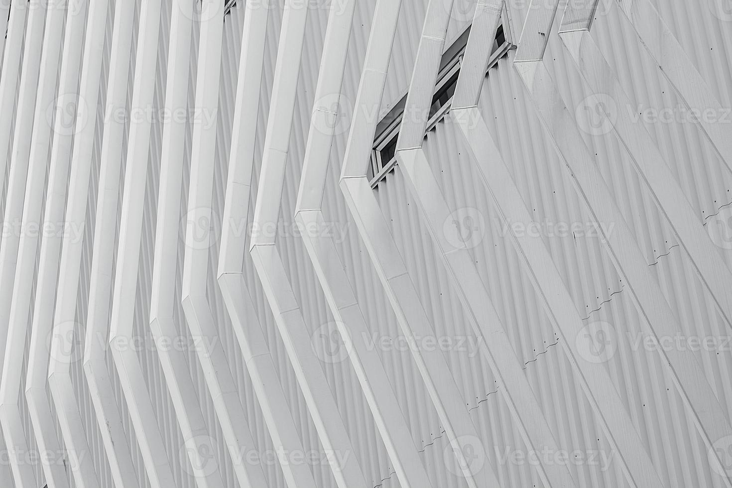 White facade building abstract background. Modern futuristic facade building. Steel cladding corrugated metal sheet facade of building. Exterior building wall architecture. Facade pattern design. photo