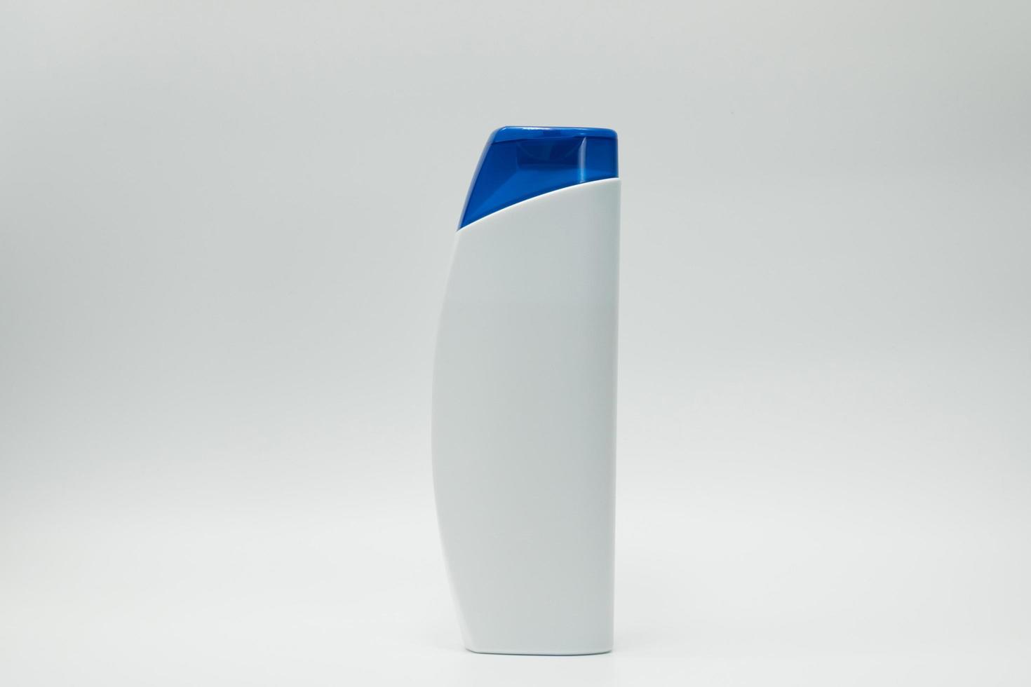 Shampoo or conditioner bottle with blue dispenser pump isolated on white background with blank label and  copy space. Use for advertise shampoo or conditioner. Cosmetic product package. Beauty product photo