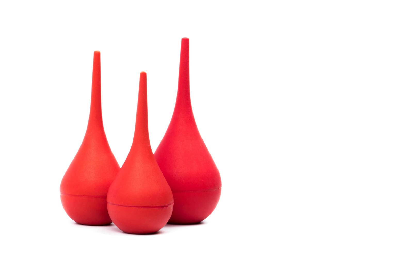 Red rubber syringe ball isolated on white background. Nasal aspirator. Baby ear syringe ball. Snot sucker and mucus sucker. Laboratory tool. Rubber suction syringe bulb. Ear washing squeeze bulb. photo