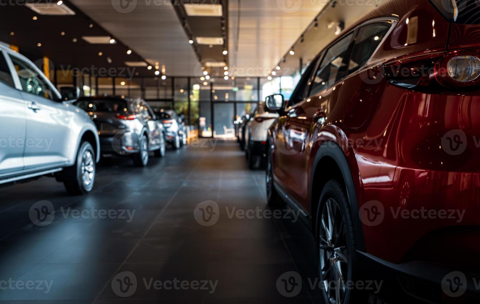 Rearview car parked in luxury showroom. Car dealership office. New car parked in modern showroom. Car for sale and rent business concept. Automobile leasing and insurance concept. Electric automobile. photo