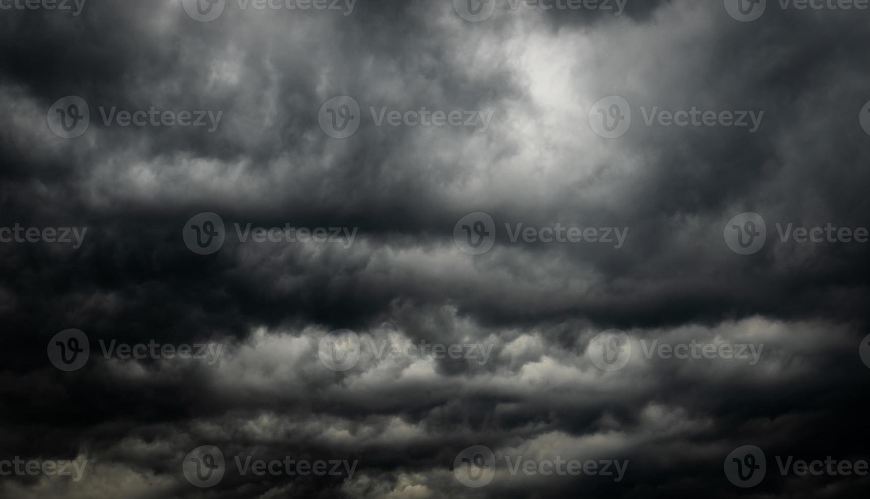 Dramatic dark sky and clouds. Cloudy sky background. Black sky before thunder storm and rain. Background for death, sad, grieving or depression. photo