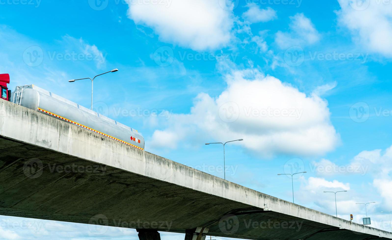 Bottom view of elevated concrete highway. Overpass concrete road. Road flyover structure. Modern motorway. Transportation infrastructure. Concrete bridge engineering construction. Bridge architecture. photo