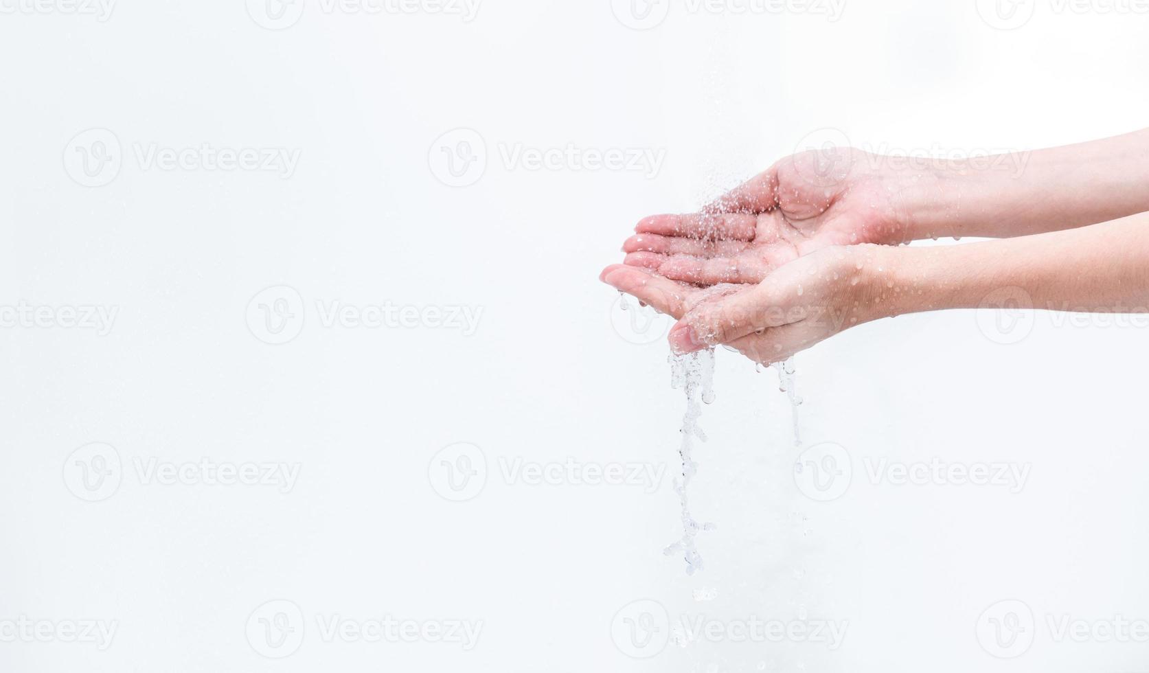 Woman washing hand with water isolated on white background. Good personal hygiene concept. First step to clean dirty hands for prevent flu and coronavirus. Adult woman hand soak and wet with water. photo