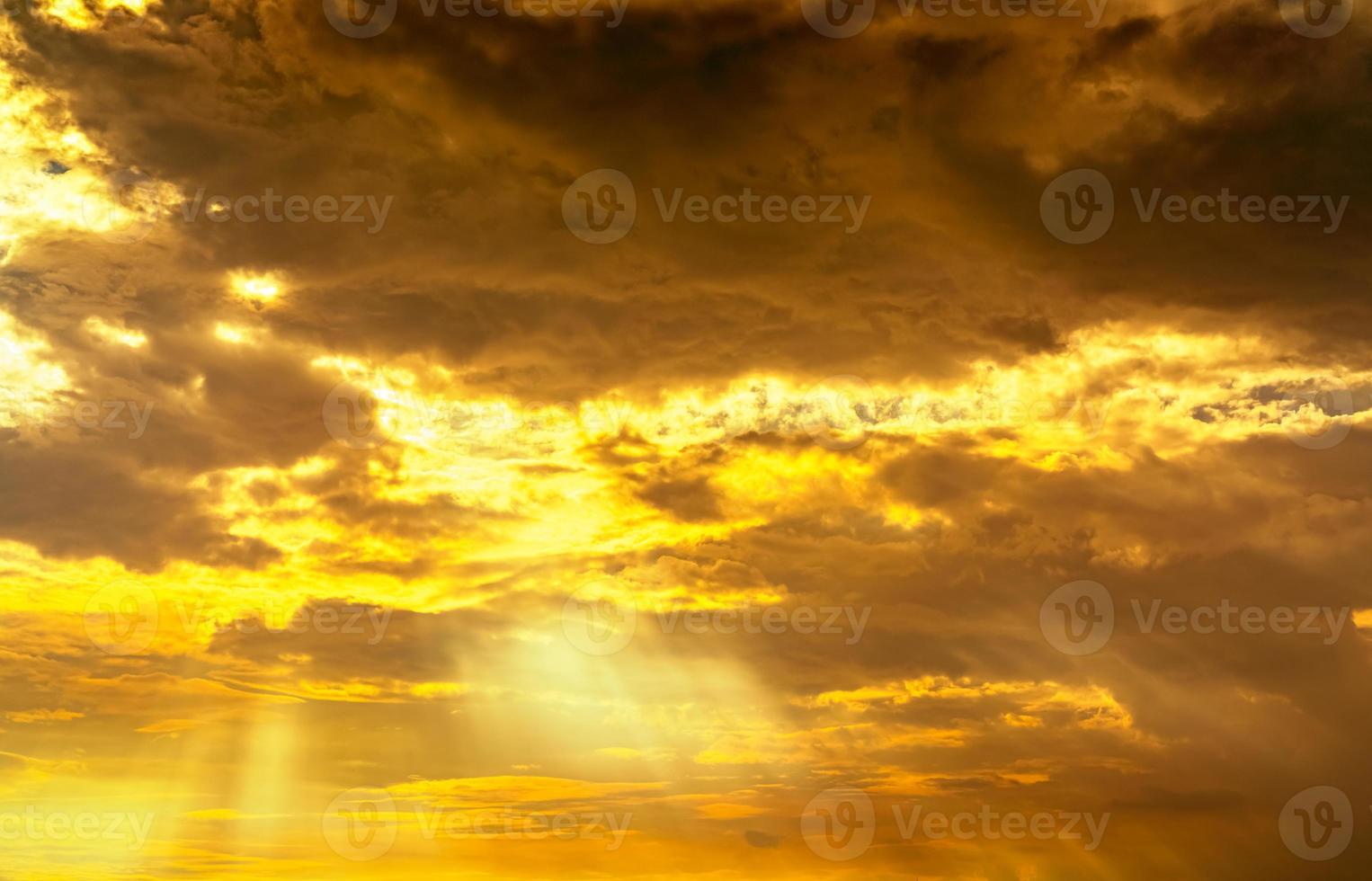 God light. Dramatic golden cloudy sky with sun beam. Yellow sun rays through  golden clouds. God light from heaven for hope and faithful concept. Believe in god. Beautiful sunlight sky background. photo