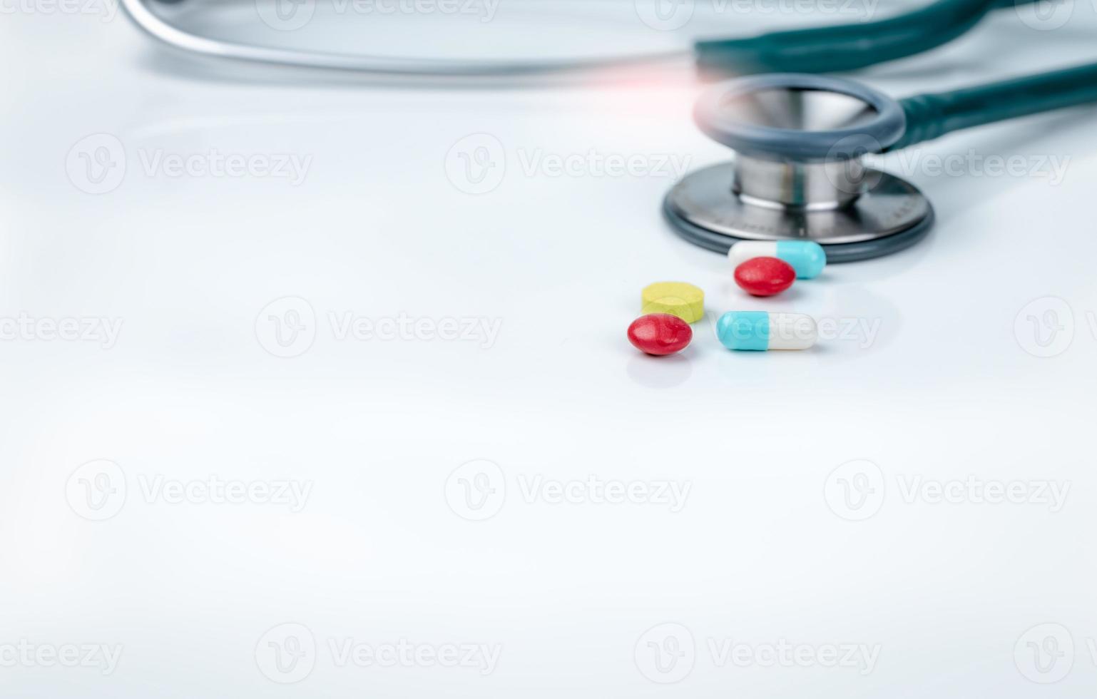 Stethoscope, capsule, and tablets pills on doctor table or nurse desk. Health checkup. Medical healthcare and medicine background. Physician tool for patient diagnosis. Cardiology doctor equipment. photo