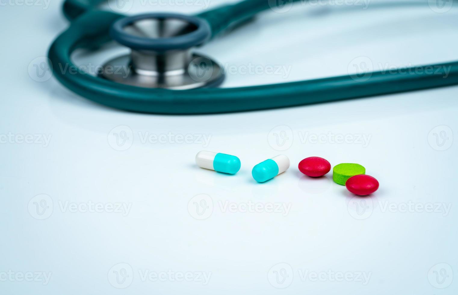 Stethoscope, capsule, and tablets pills on doctor table or nurse desk. Health checkup. Medical healthcare and medicine background. Physician tool for patient diagnosis. Cardiology doctor equipment. photo