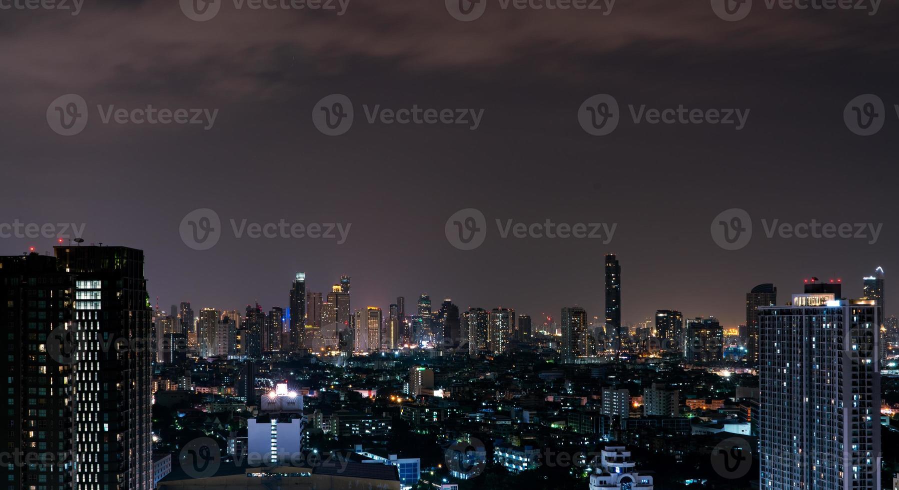 Cityscape of modern building in the night. Modern architecture office building. Skyscraper with beautiful evening sky. Business and financial center building. Apartment in the city with night light. photo