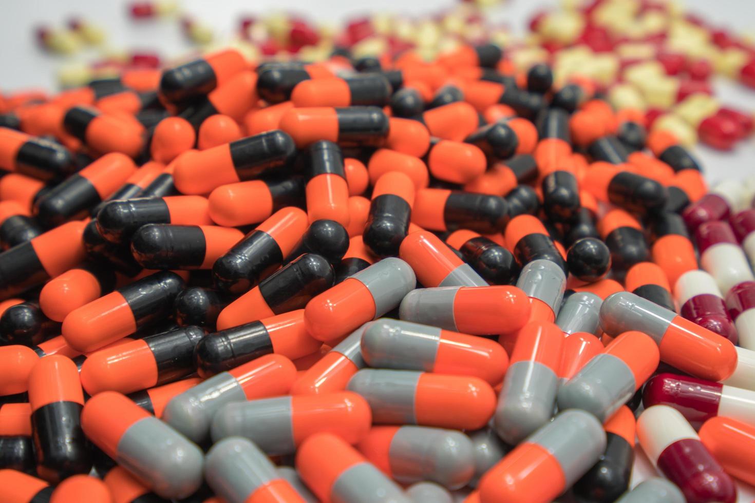 Pile of colorful antibiotic capsule pills. Pharmaceutical industry. Drug production. Pharmacy drugstore background. Global healthcare. Drug interaction. Antibiotic drug resistance concept. photo