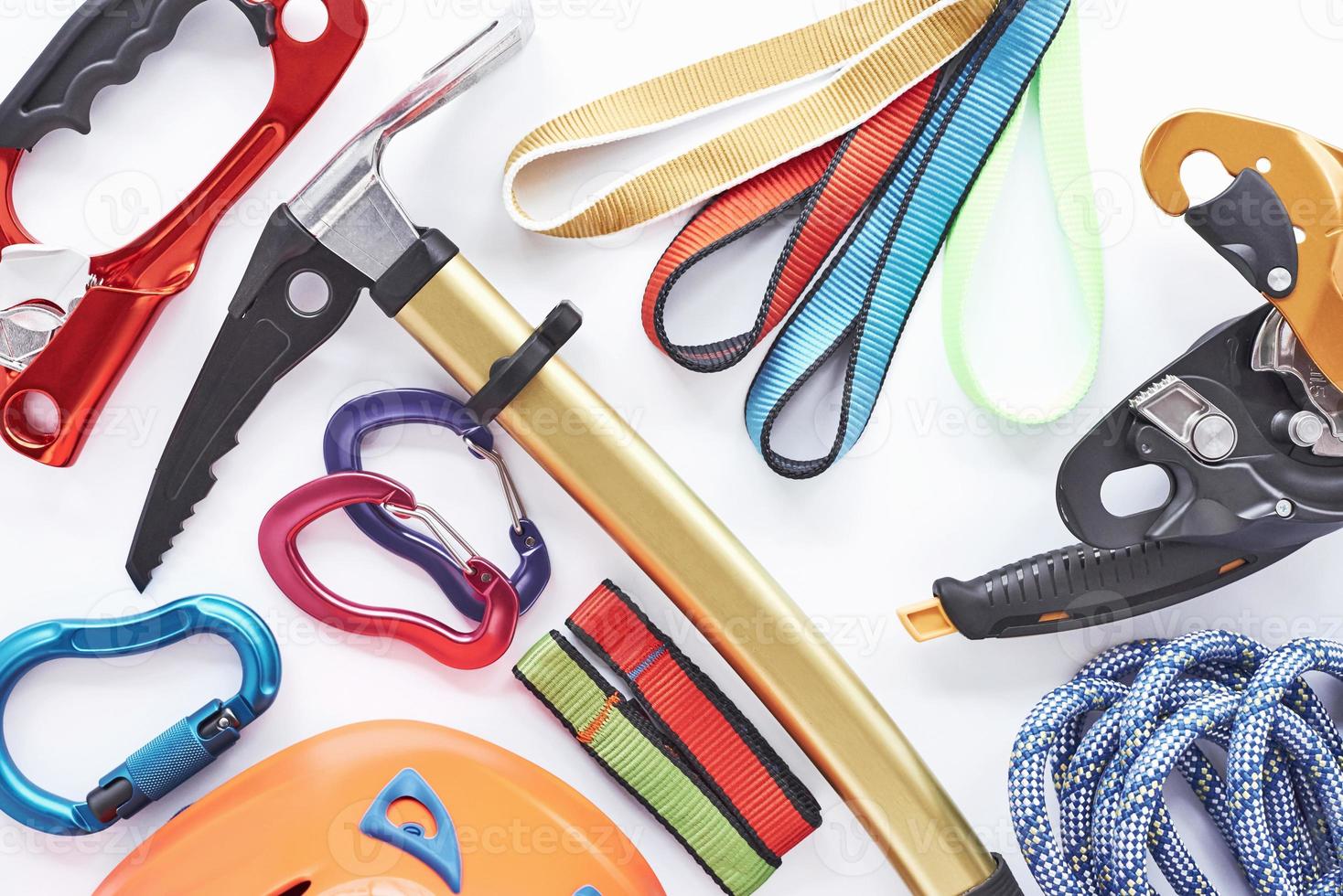 Group of instruments. Top view. Climbing equipment for the safeness lying on the white table. Conception of extreme sports photo