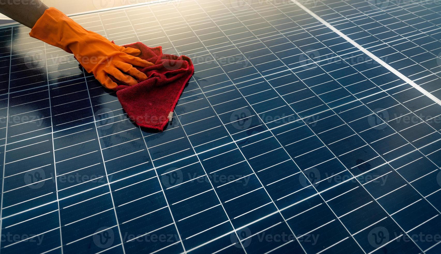 Man cleaning solar panel on roof. Solar panel or photovoltaic module maintenance. Sustainable resource and renewable energy for go green concept.  Solar power for green energy. Technology for future. photo