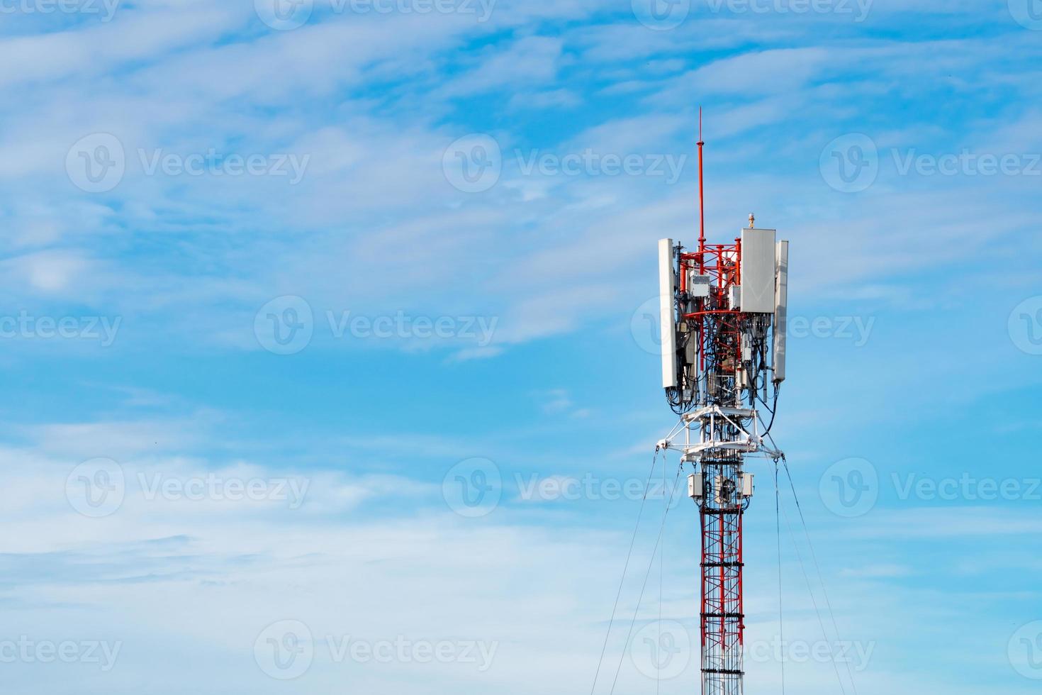 Telecommunication tower with blue sky and white clouds background. Antenna on blue sky. Radio and satellite pole. Communication technology. Telecommunication industry. Mobile or telecom 4g network. photo