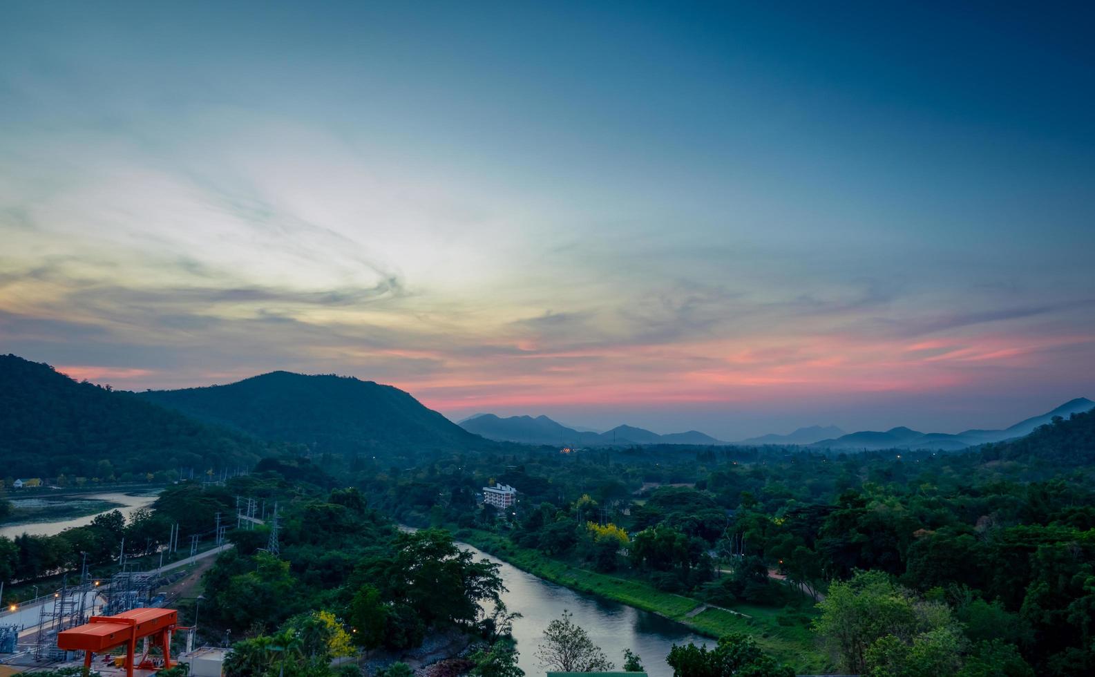 Beautiful nature landscape of mountain range with sunrise sky and clouds. City in mountain valley in Thailand. Scenery of mountain layer with morning sunrise. Tropical forest. Nature background. photo