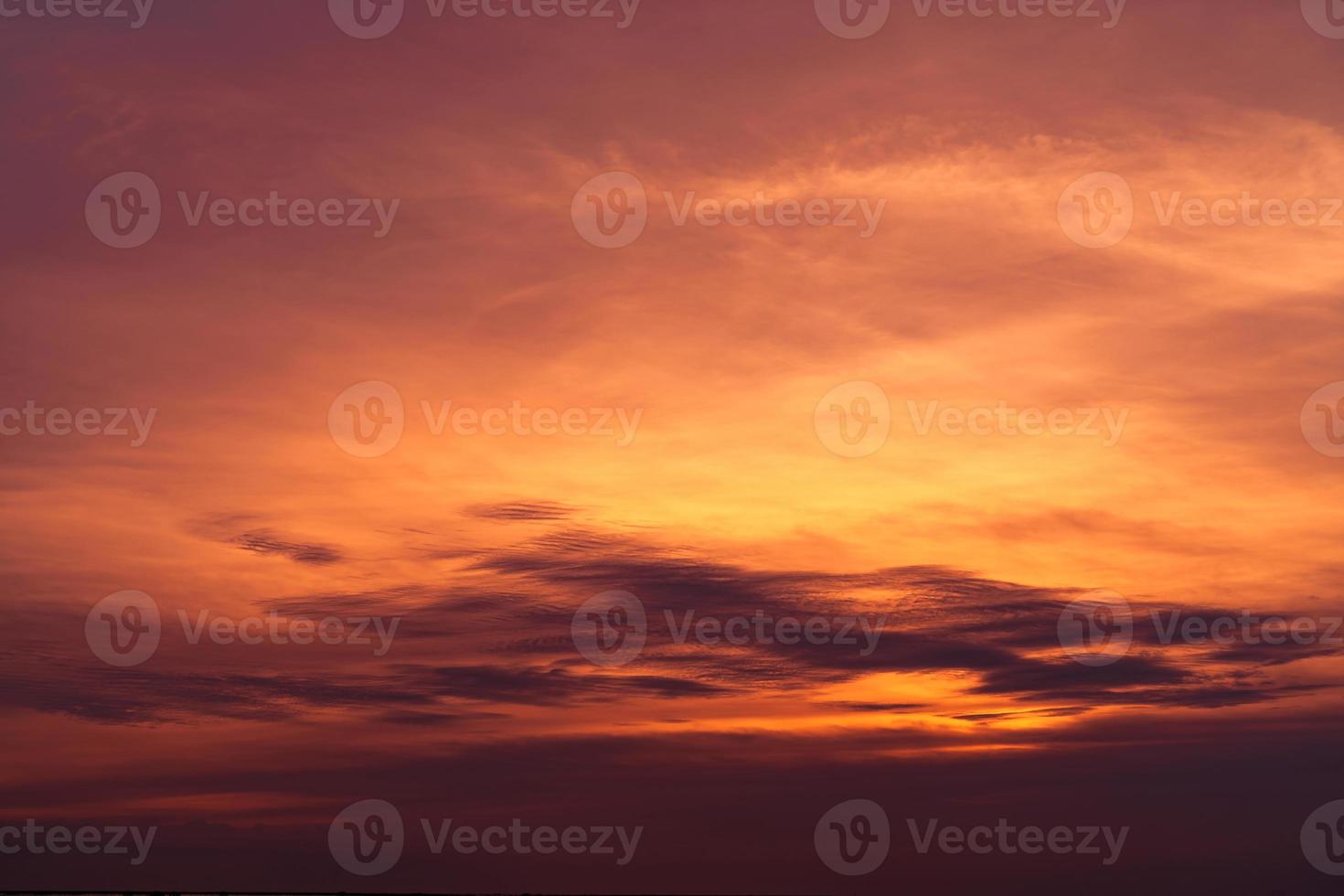 Beautiful sunset sky. Golden sky at sunset. Art picture of sky and dark clouds at dusk. Peaceful and tranquil concept. Twilight sky in evening. Background for life quote. Red, orange and dark clouds. photo