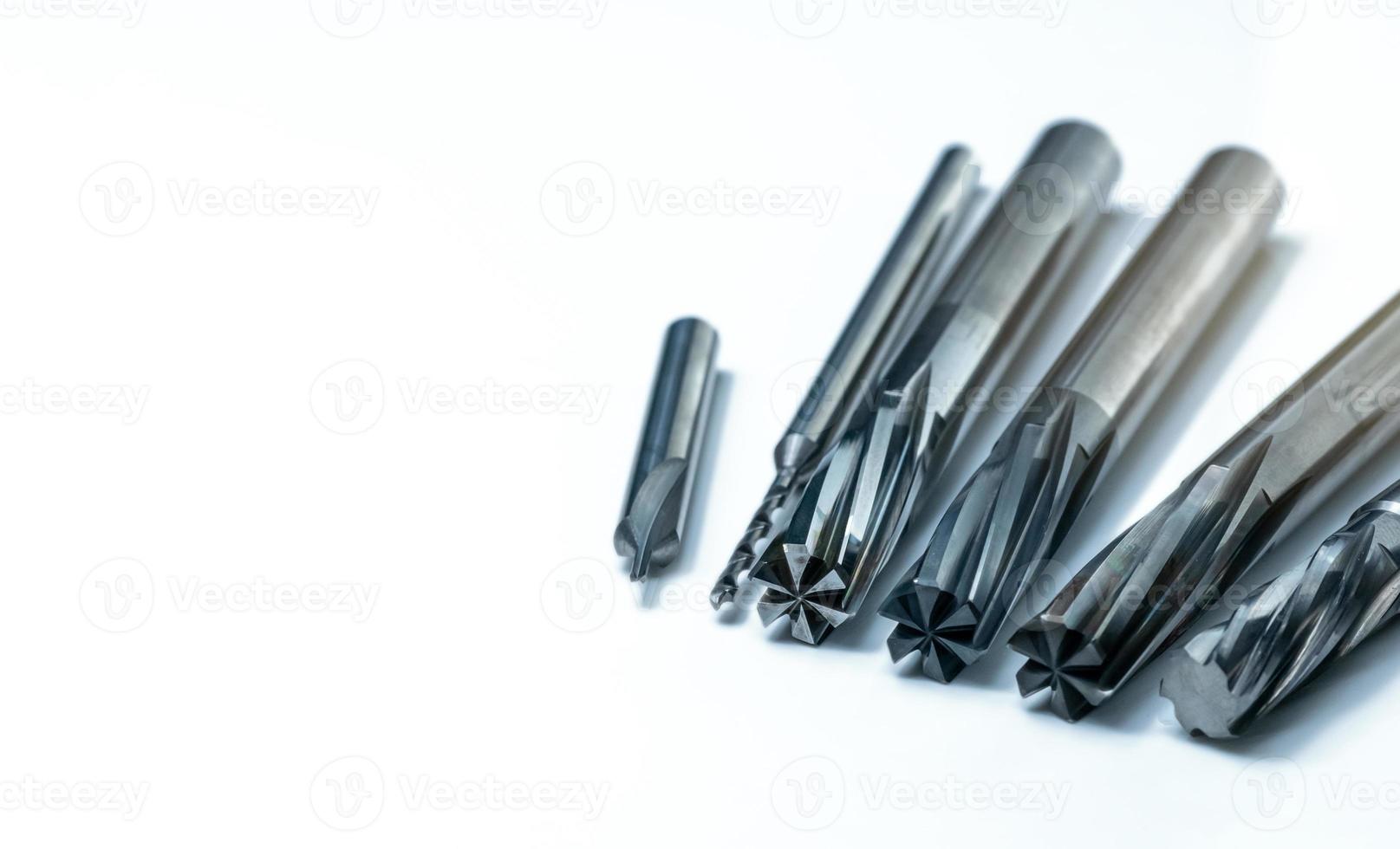 Special tools isolated on white background. Made to order special tools. Coated step drill, reamer, and endmill detail. HSS cemented carbide. Carbide cutting tool for industrial applications. photo