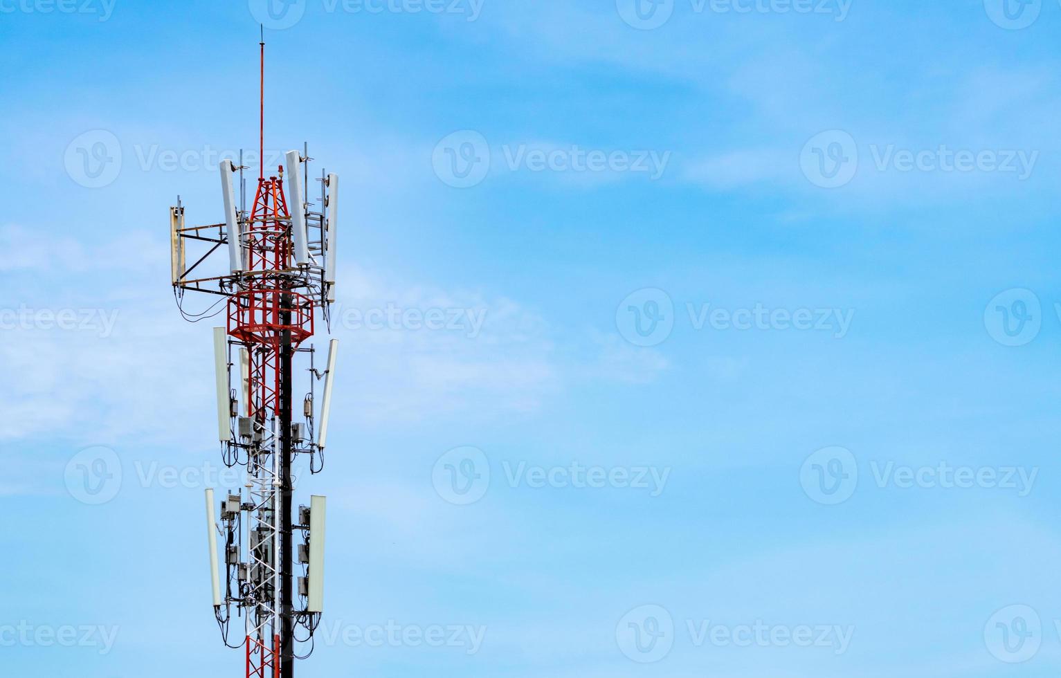 Telecommunication tower with blue sky and white clouds background. Antenna on blue sky. Radio and satellite pole. Communication technology. Telecommunication industry. Mobile or telecom 4g network. photo