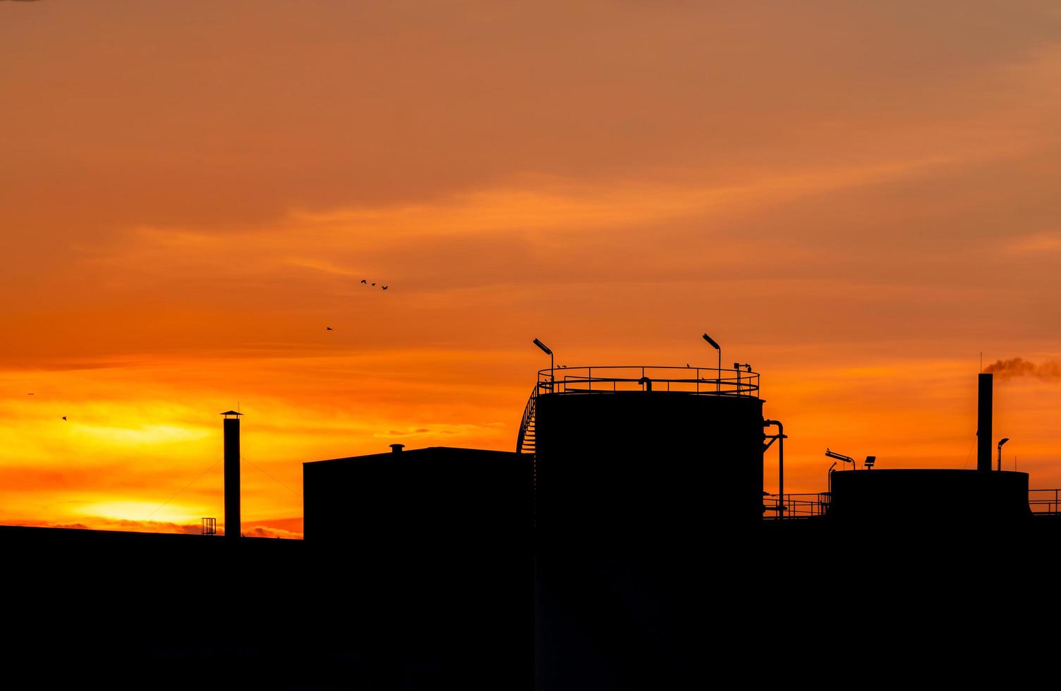 Gas turbine electrical power plant. Energy for support factory in industrial estate. Natural gas tank. Small gas power plant. Power plant using natural gas for fuel. Green energy. Dramatic sunset sky. photo