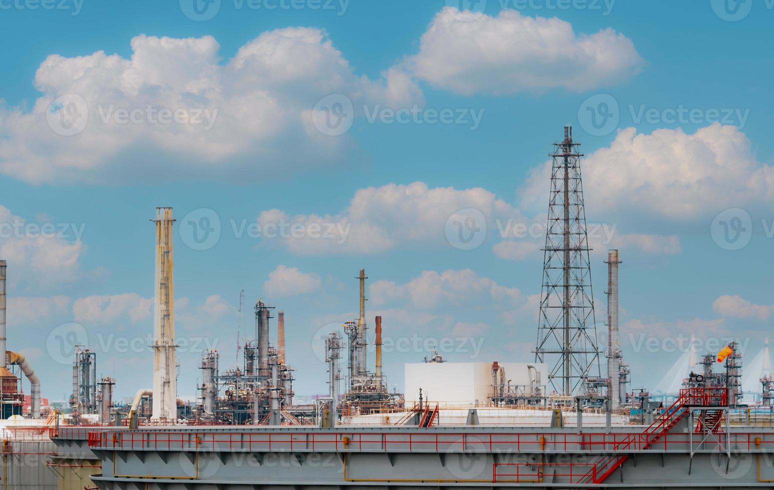 Oil refinery or petroleum refinery plant with blue sky background. Power and energy industry. Oil and gas production plant. Petrochemical industry. Natural gas storage tank. Petroleum business. photo