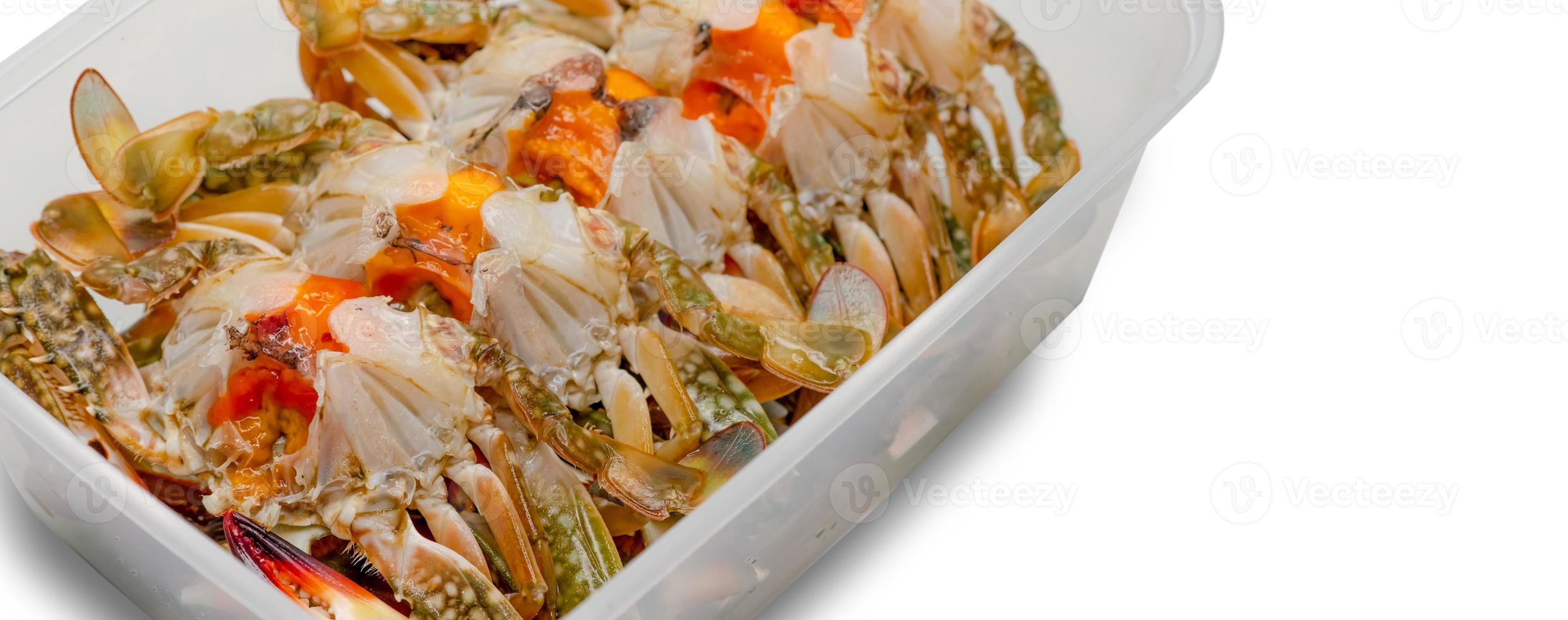 Pickled crab eggs in fish sauce pack in plastic box for delivery. Seafood delivery business. Exotic menu in Thailand. Pickled crab eggs in disposable plastic container isolated. Sea food industry. photo