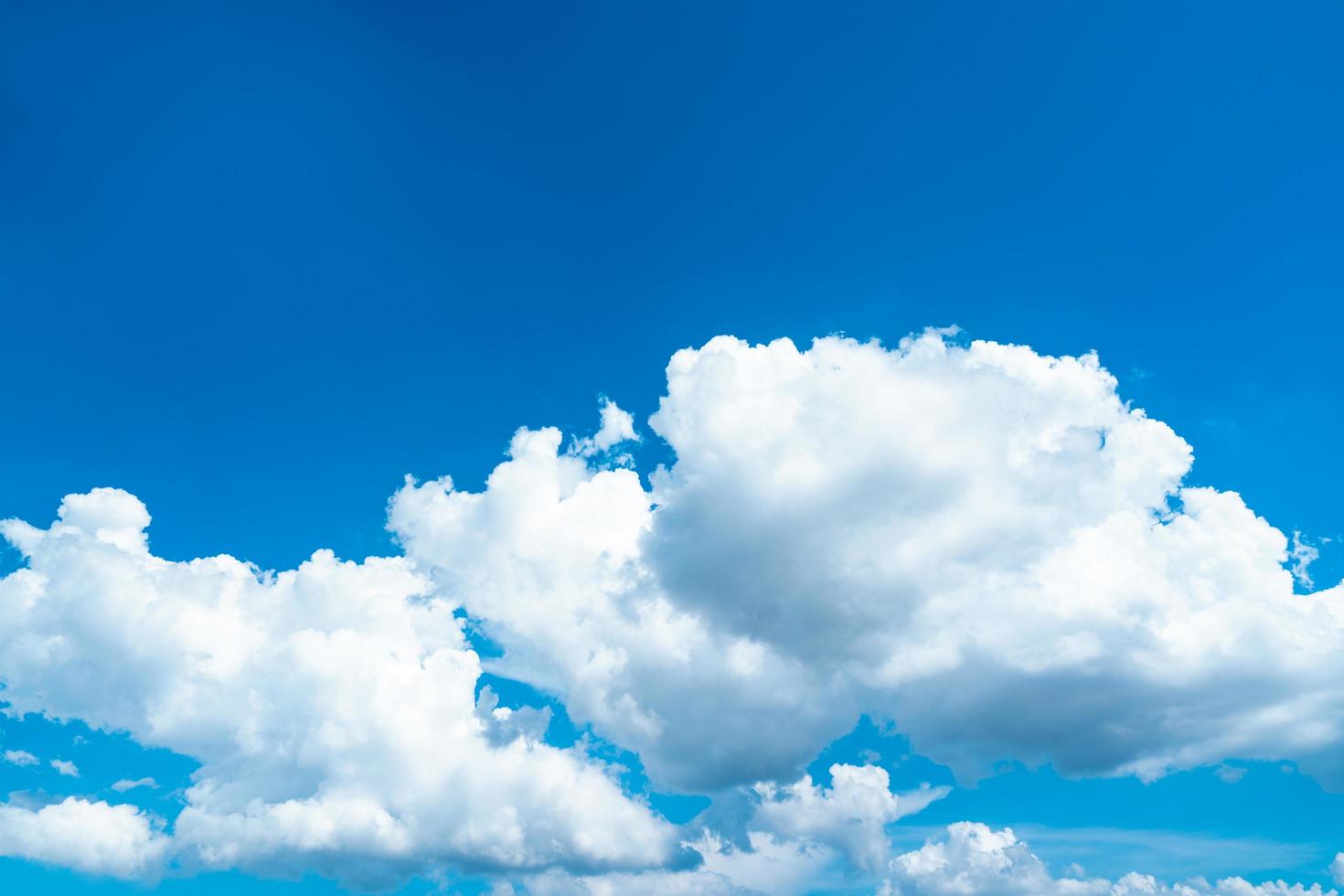 Beautiful blue sky and white cumulus clouds background. Background for peace, summer, bright day. Use for happy mood, fun and vacation day on summer background photo