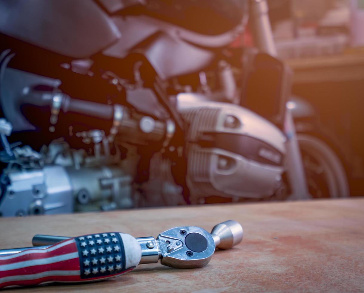 Tool on the table with single cylinder head cover of a motorcycle photo