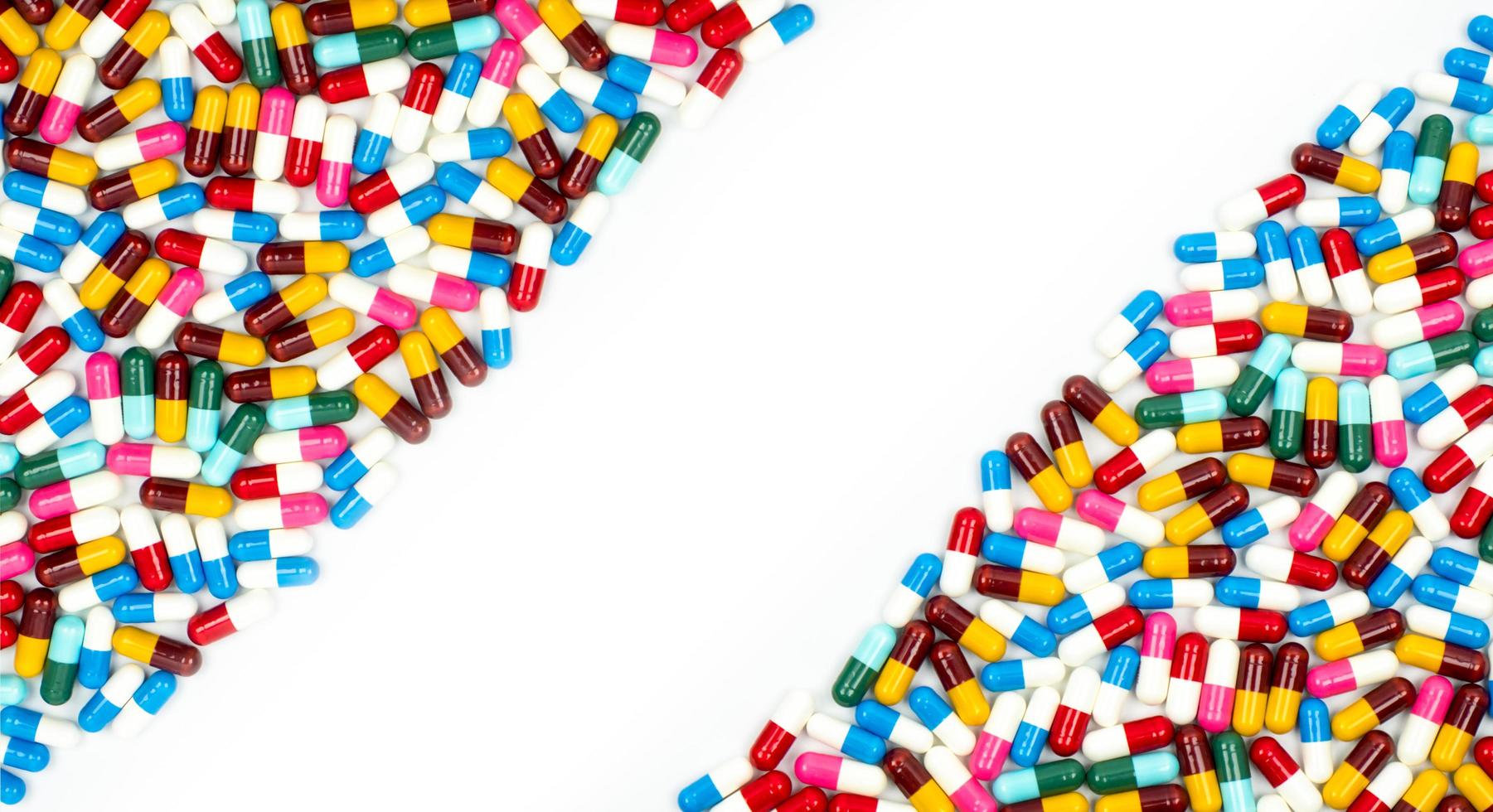 Colorful of antibiotic capsules pills on white background with beautiful pattern and copy space. Drug resistance concept. Antibiotics drug use with reasonable and global healthcare concept. photo