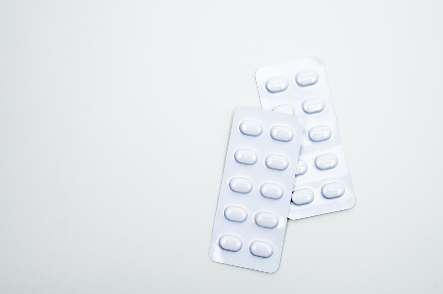 Tablets pill in white blister pack for light resistance packaging isolated on white background. Medicine for treatment NCDs. Elderly people disease. photo