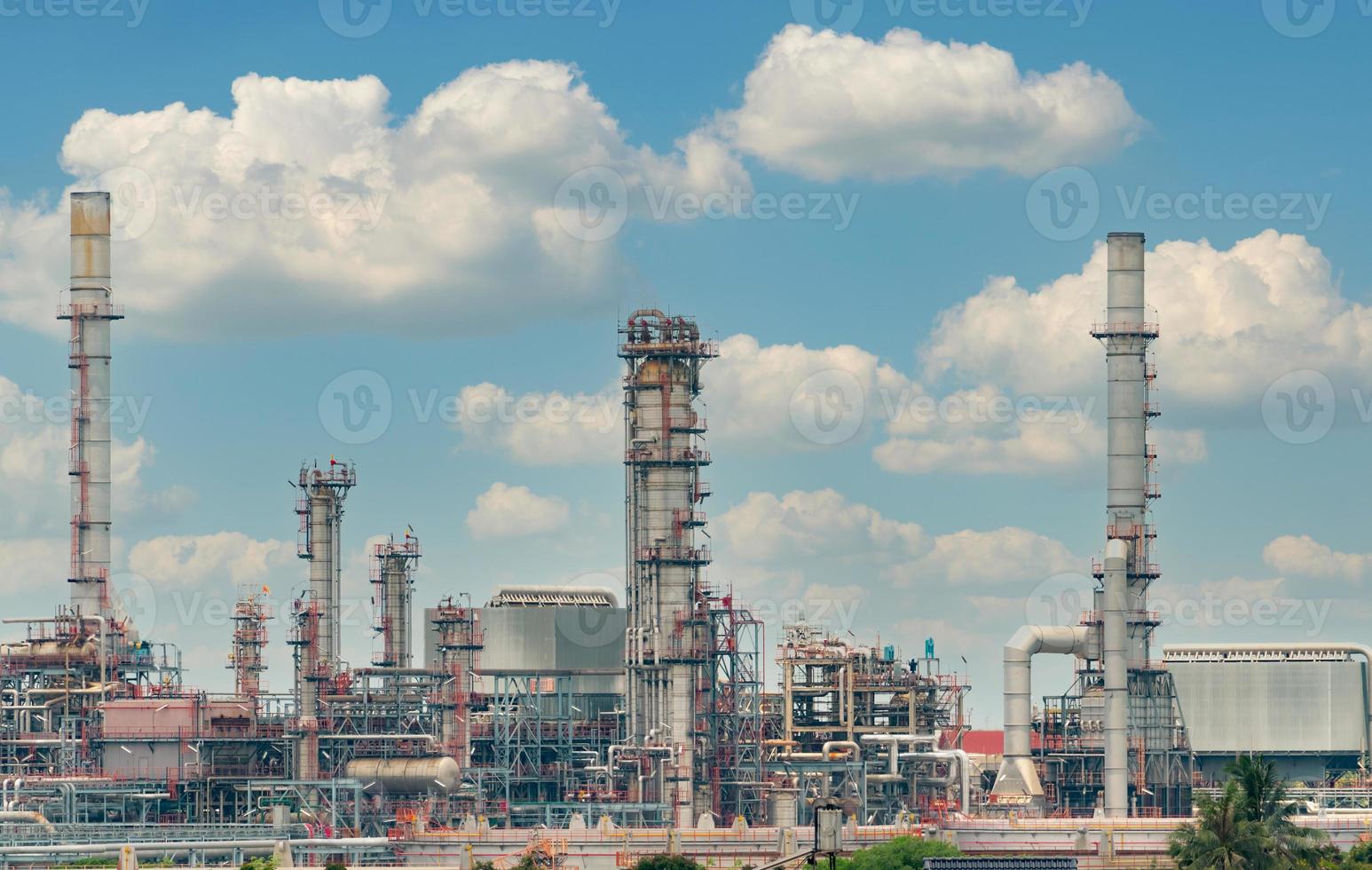 Oil refinery or petroleum refinery plant with blue sky background. Power and energy industry. Oil and gas production plant. Petrochemical industry. Natural gas storage tank. Petroleum business. photo