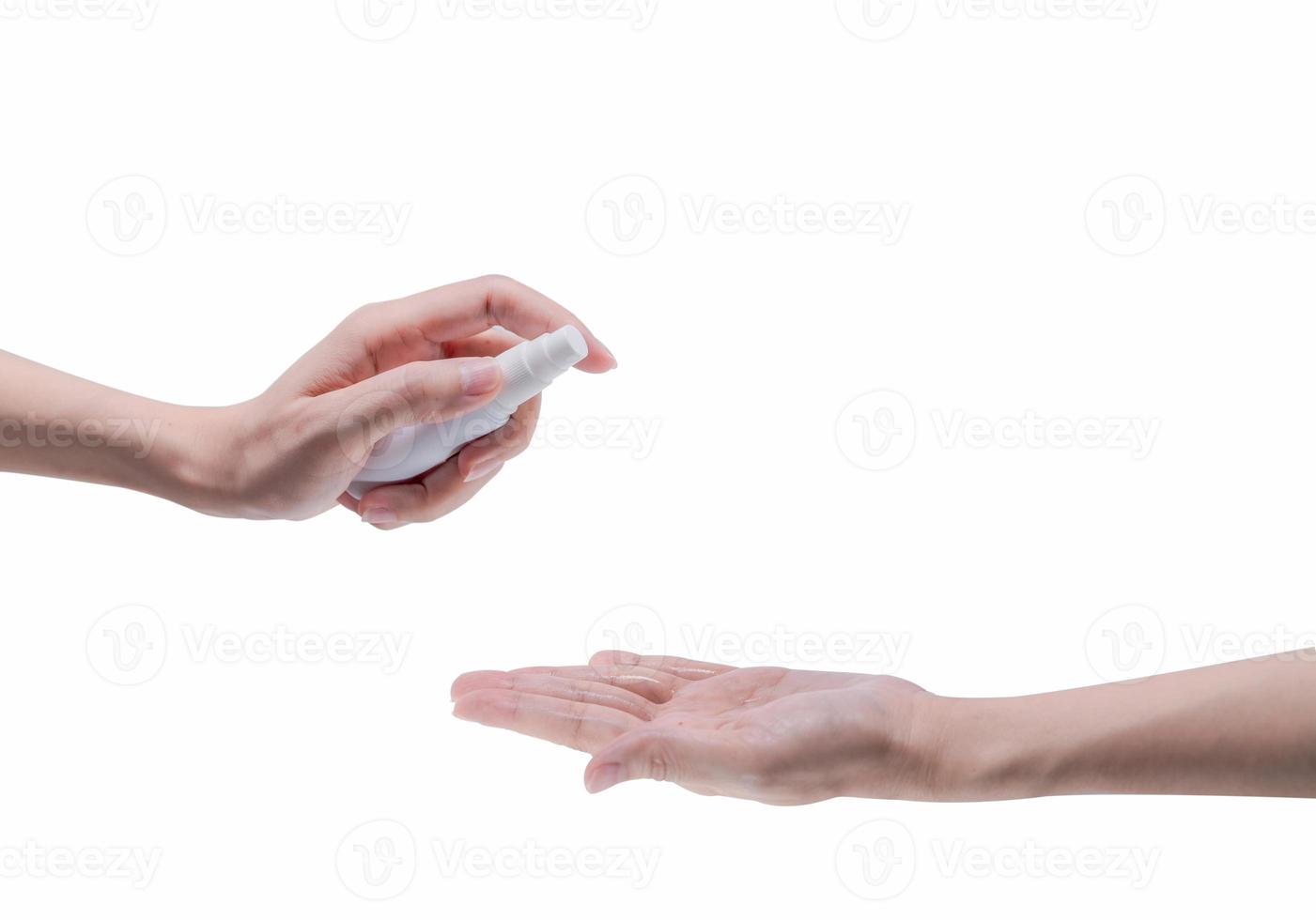 Woman hand hold alcohol bottle and spray on palm to protect and kill coronavirus and cleaning hand. Personal hygiene to prevent coronavirus or flu epidemic. Cleaning hands from germs, virus, bacteria. photo