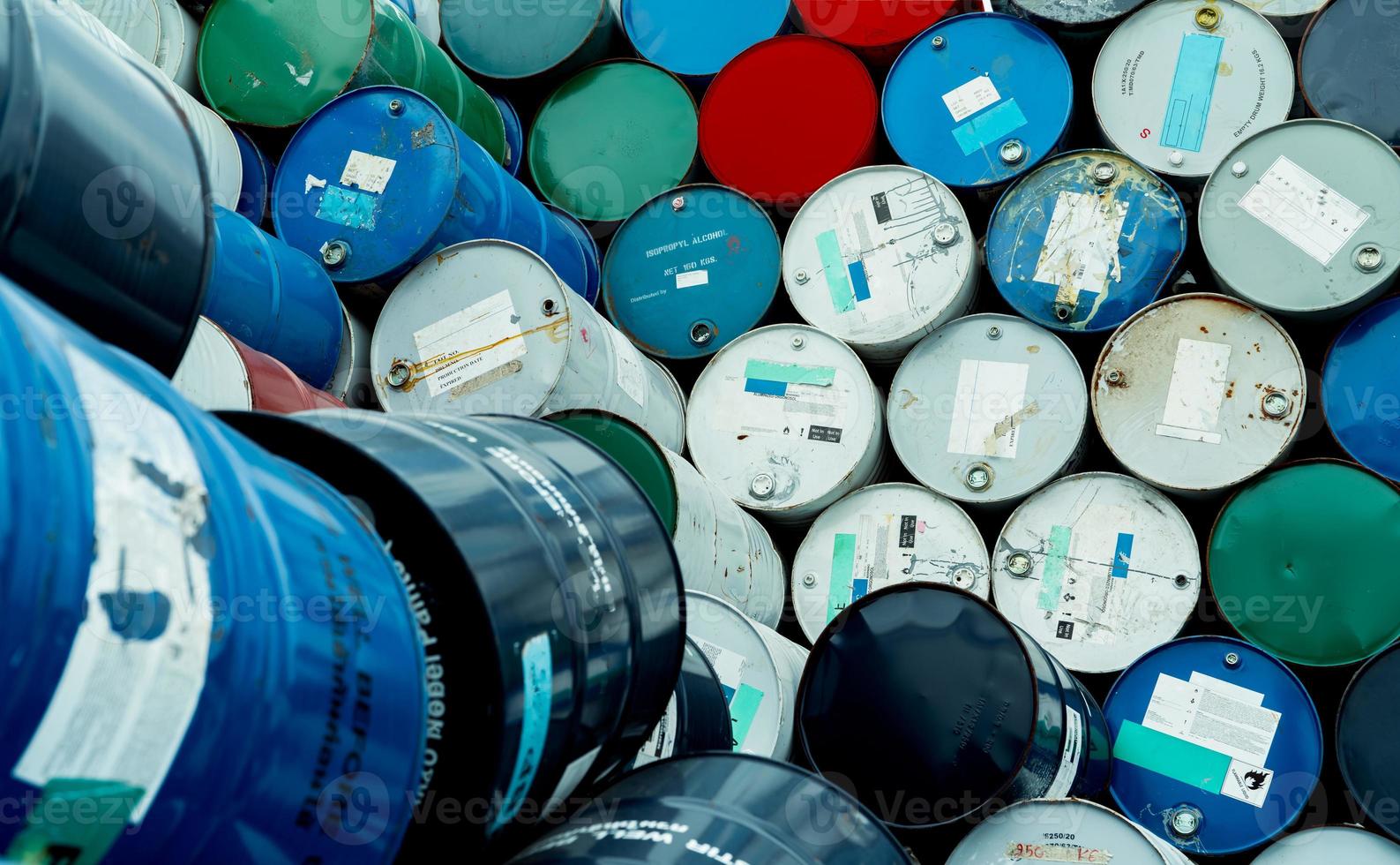 Old chemical barrels. Blue, red, and green chemical drum. Steel tank. Hazard chemical barrel with flammable liquid warning label. Industrial waste. Isopropyl alcohol and aluminized orgonosol barrels. photo