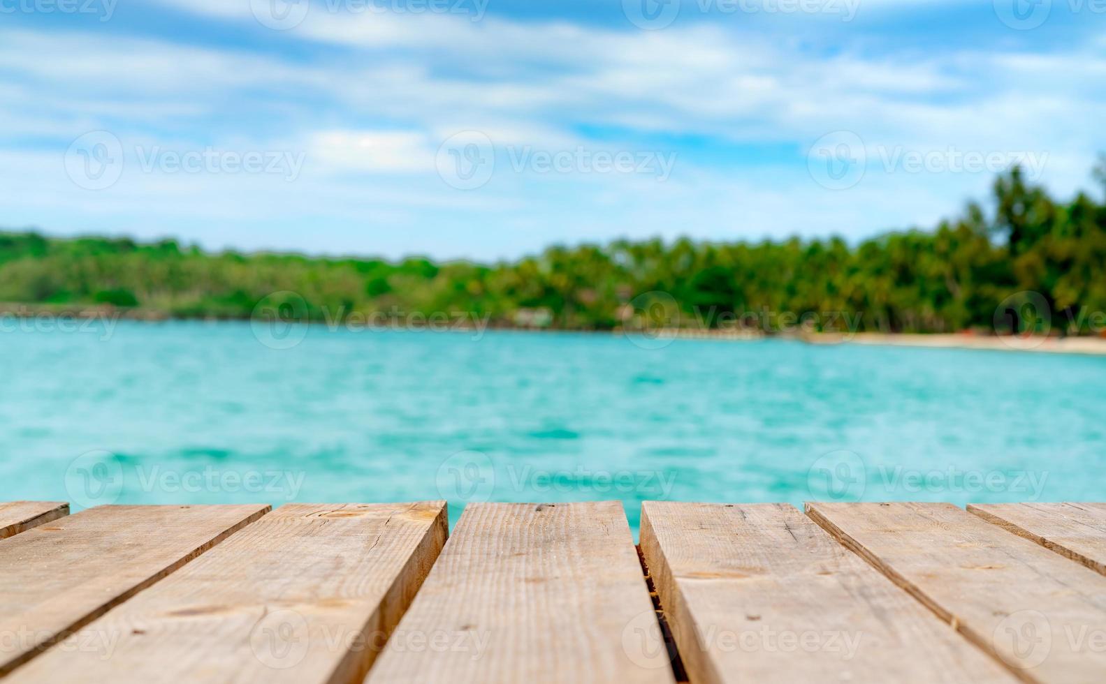 Product display for summer promotion. Wooden bridge on blurred water, coconut tree and sand beach. Empty space for product display montage. Banner for advertise on online media, Business presentation. photo