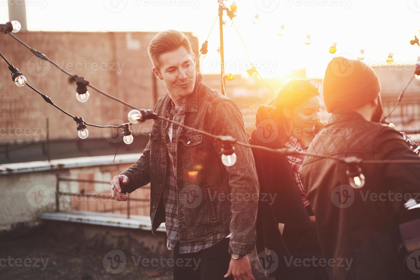 Guy walk with style. Rooftop party with acoustic guitar and music. Beautiful young people photo