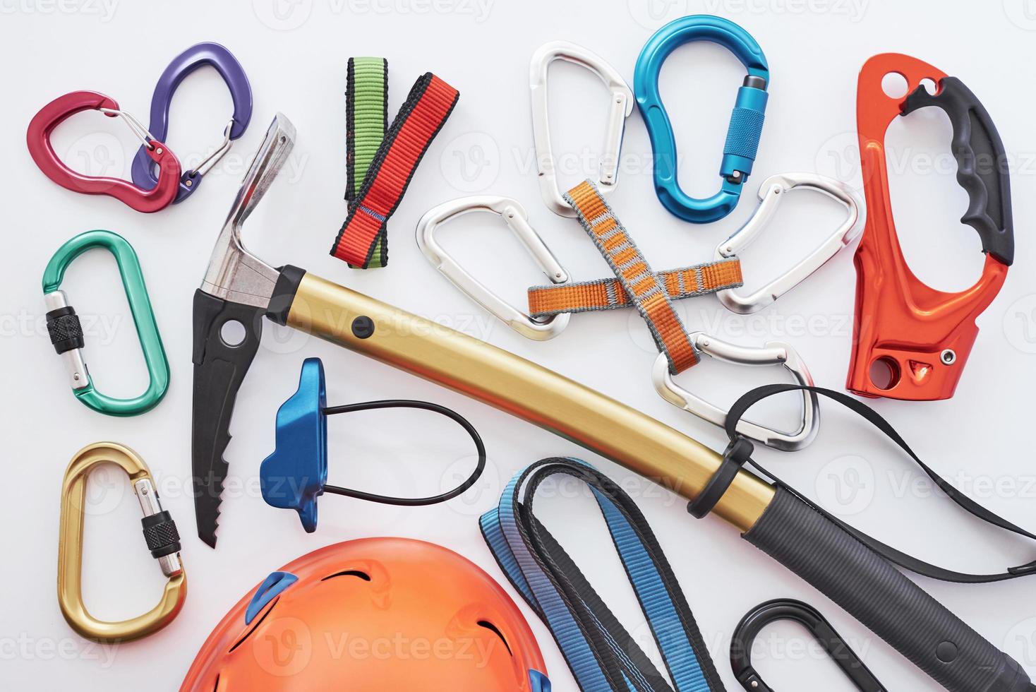 Many of the objects. Top view. Climbing equipment for the safeness lying on the white table. Conception of extreme sports photo