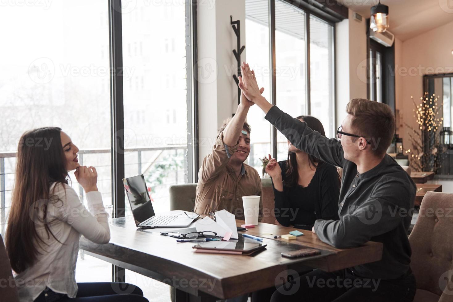 Work well done. Having fun in the office room. Friendly coworkers playing around and celebrating success photo