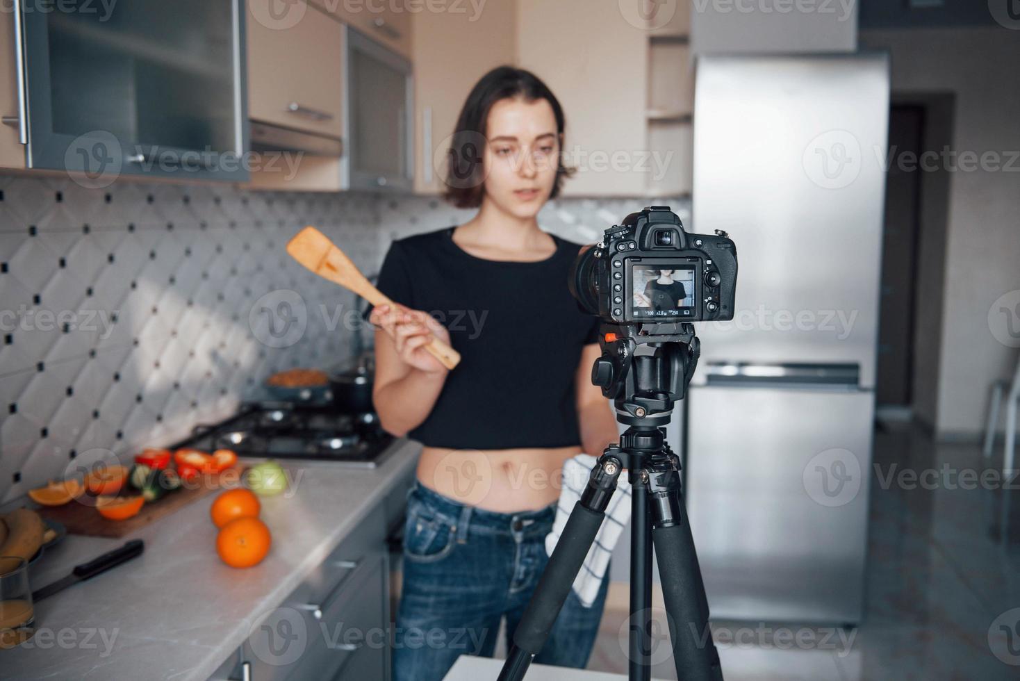 Don't blink. Girl in the modern kitchen at home at her weekend time in the morning photo