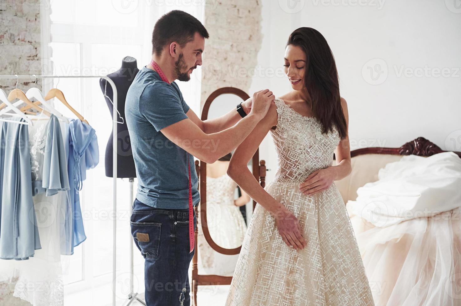 Work in progress. The process of fitting the dress in the studio of hand crafted clothes photo