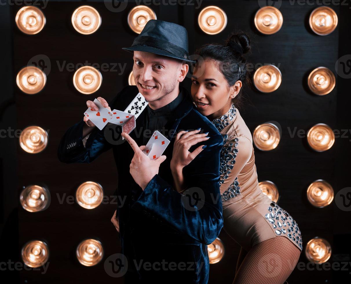 Look what I can do. Happy couple posing for the portrait. Family business of magician tricks and shows photo