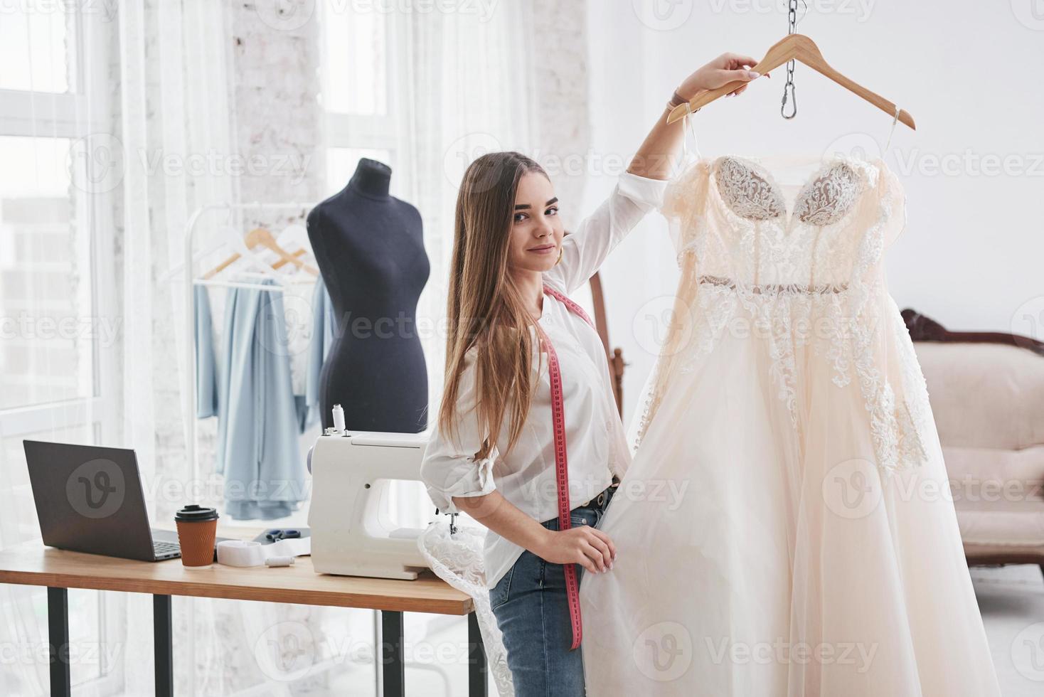 Showing the results. Female fashion designer works on the new clothes in the workshop photo