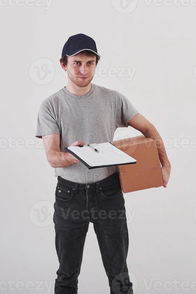Please take your order. Guy with box in hands stands against white background in the studio photo