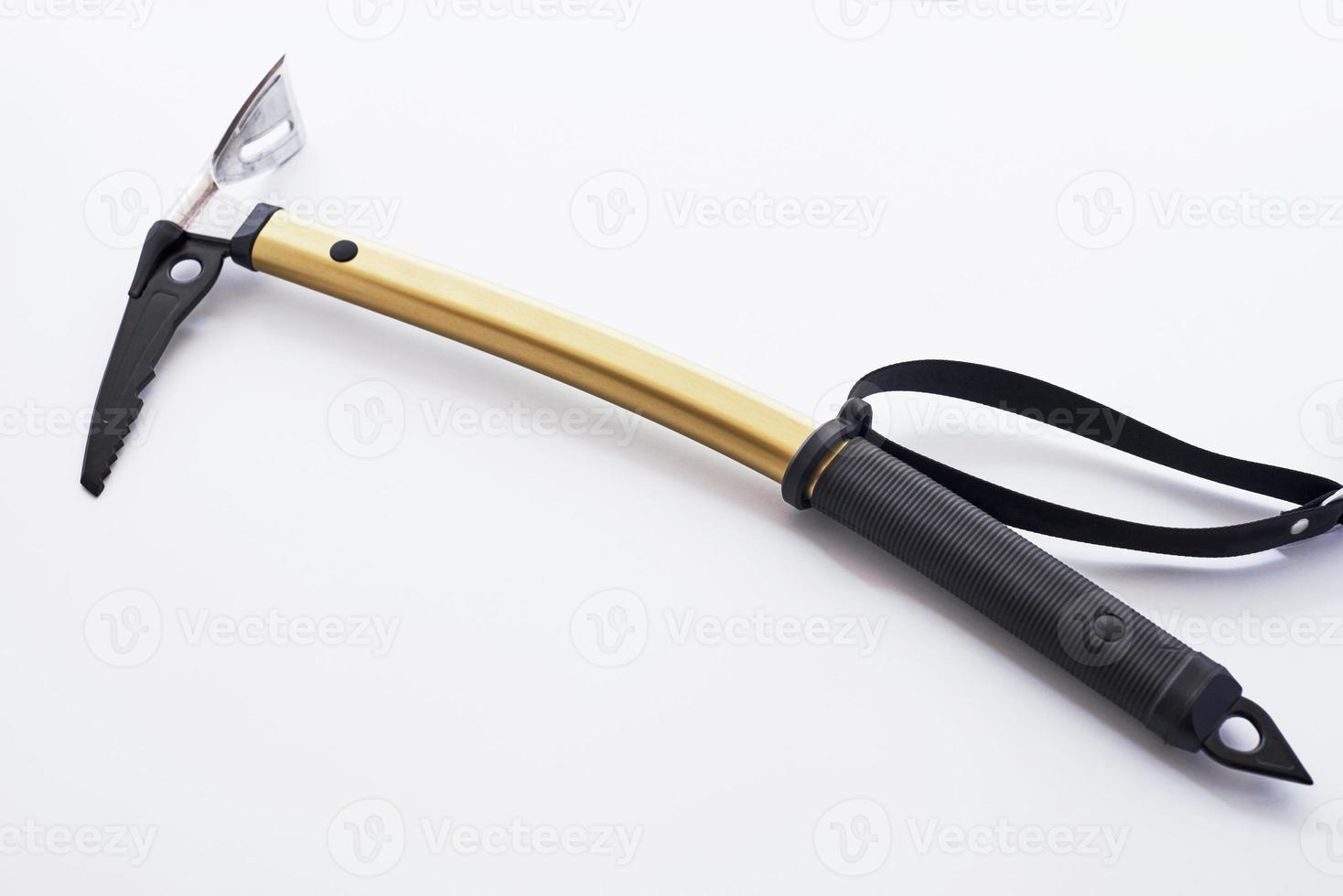 One item. Isolated photo of climbing equipment - golden colored ice axe