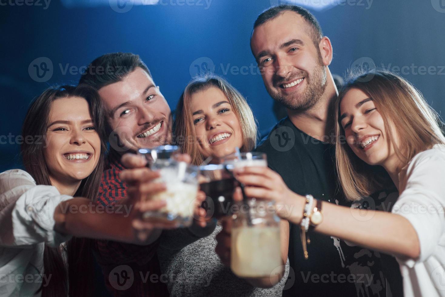 Let's spend this weekend the right way. Beautiful youth have party together with alcohol in the nightclub photo